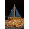 Olive wooden boat with knitted sails blue colour. 