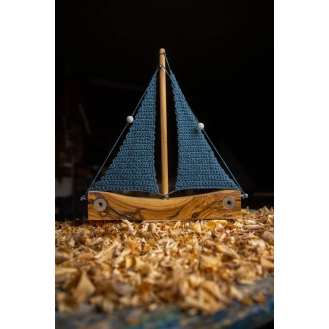 Olive wooden boat with knitted sails blue colour. 